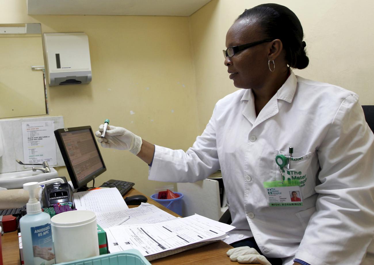 Phlebotomist Mishi Mohammed holds a blood sample from a woman to test for HIV at the Mater Hospital, in Nairobi, Kenya, on September 10, 2015.