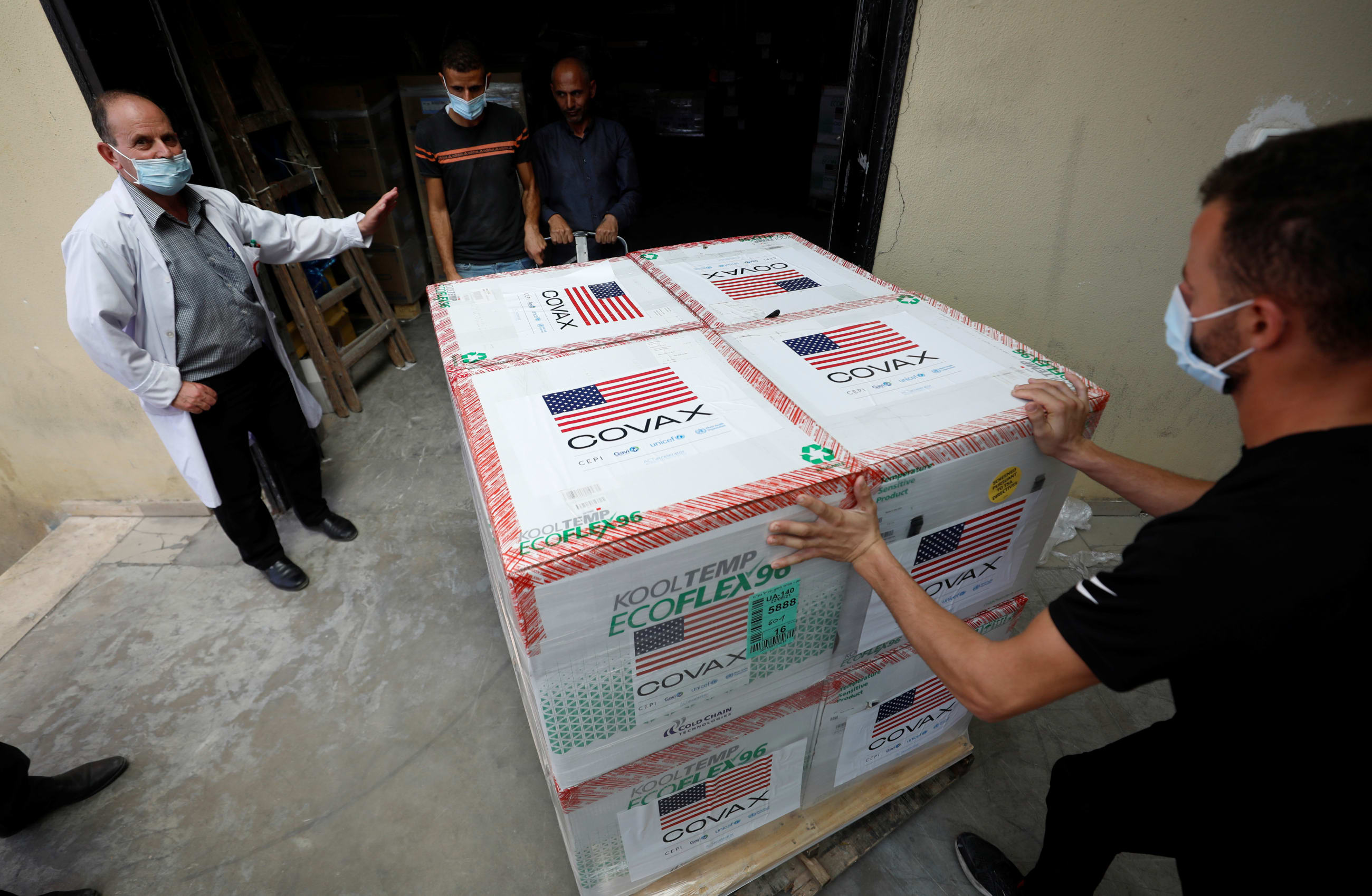 Palestinians receive a shipment of doses with the Moderna coronavirus disease vaccine donated by the U.S, in Salem village, in the Israeli-occupied West Bank, on August 24, 2021.