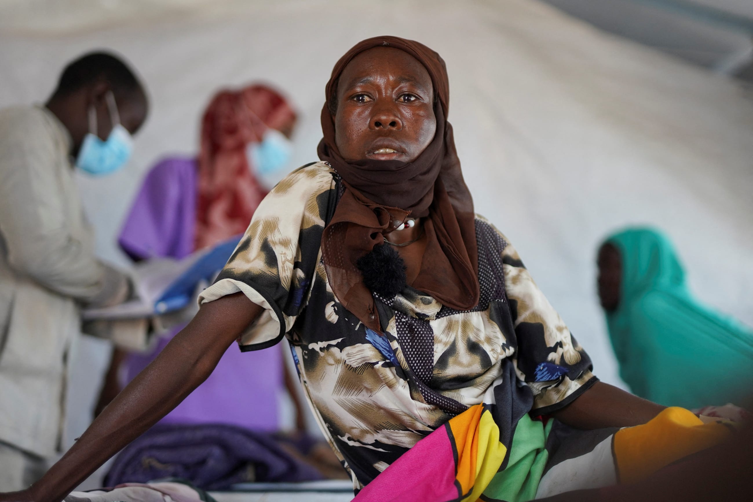 Halima Mohammed Adam, a Sudanese cholera patient, looks on as she sits on a bed at a United Nations-Run makeshift clinic, in Tawila, north Darfur, Sudan, on August 5, 2025.