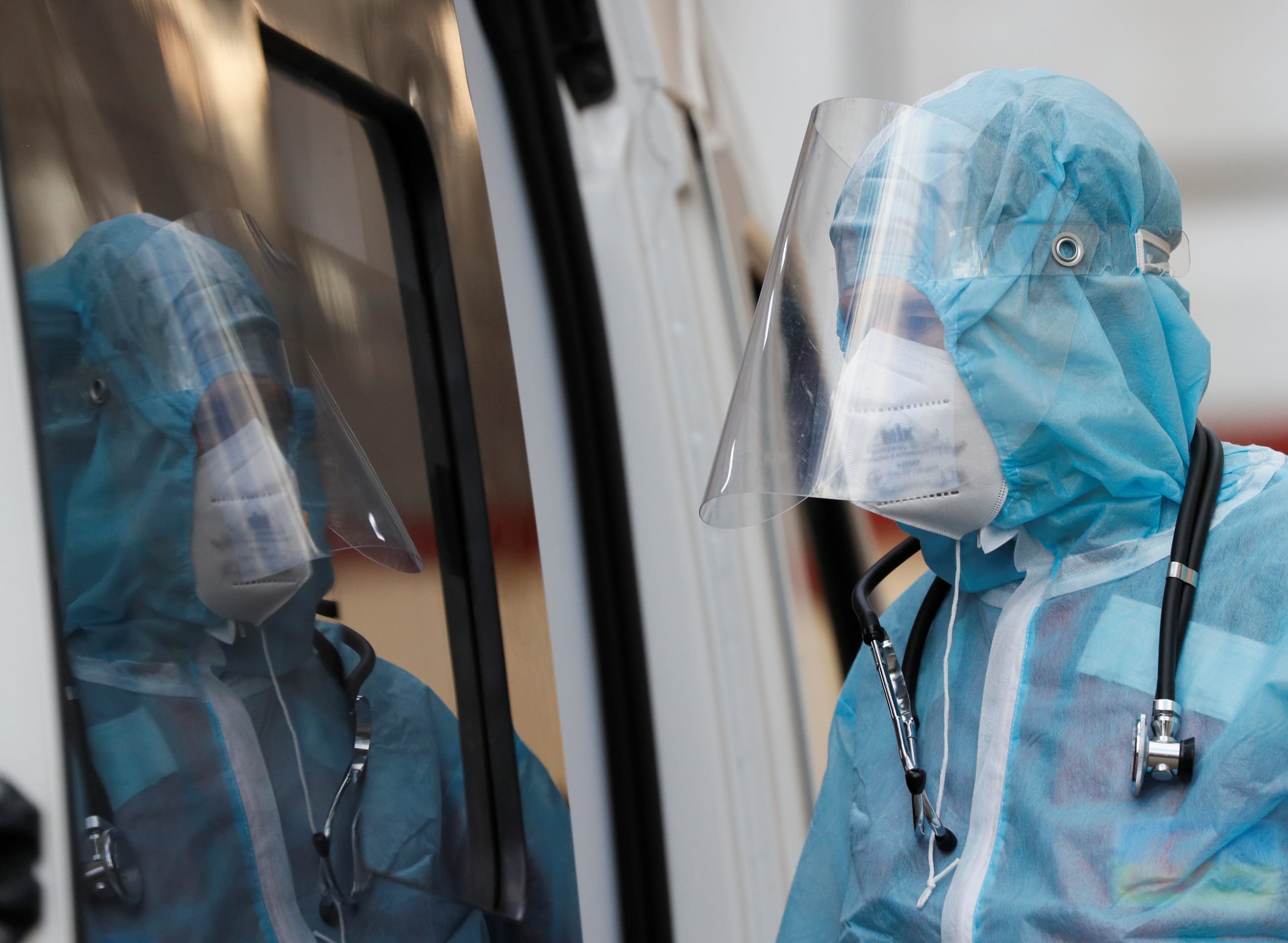 A health worker stands near an ambulance with a COVID-19 patient, in Kyiv, Ukraine, on November 9, 2021.