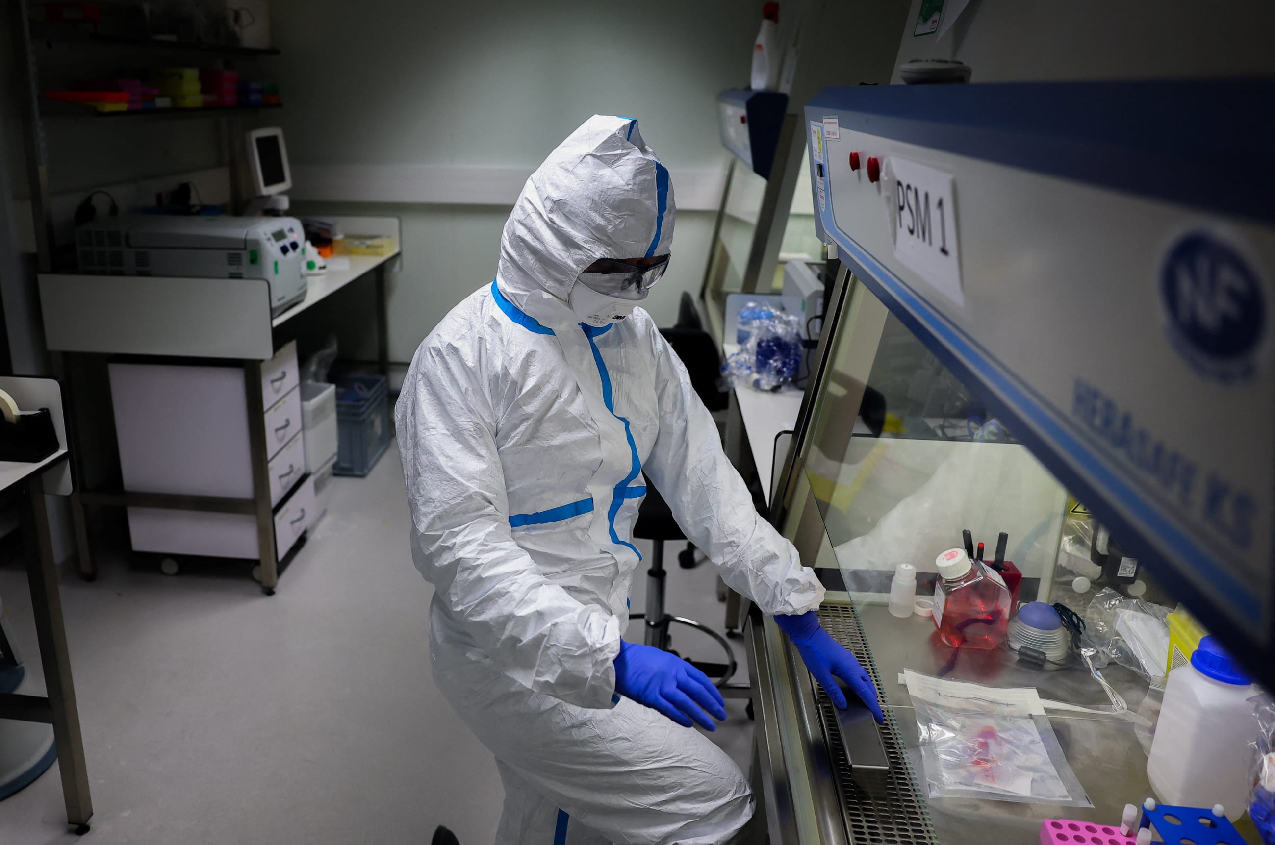 A researcher wearing a protective suit works at the Institut Pasteur, where scientists work to monitor and prevent the spread of avian influenza, in Paris, France, on November 24, 2025.