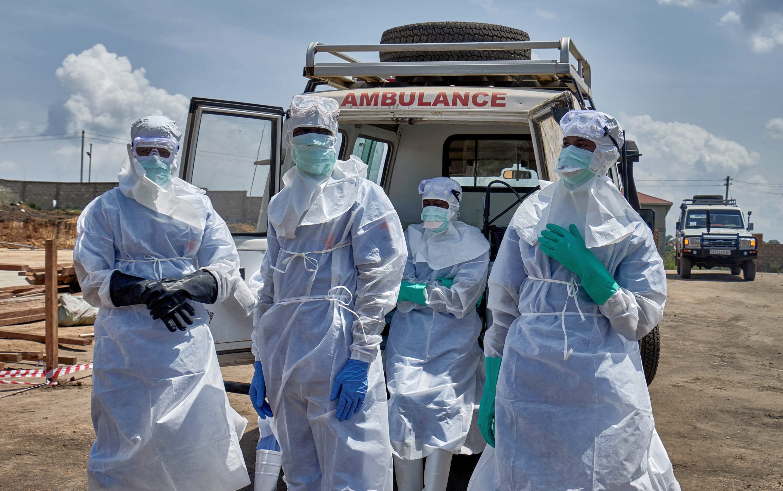 Red Cross workers wearing personal protective equipment gather after handling the coffin of a man who died of Ebola virus, in Bunia, Ituri province, Democratic Republic of Congo, on June 10, 2026.