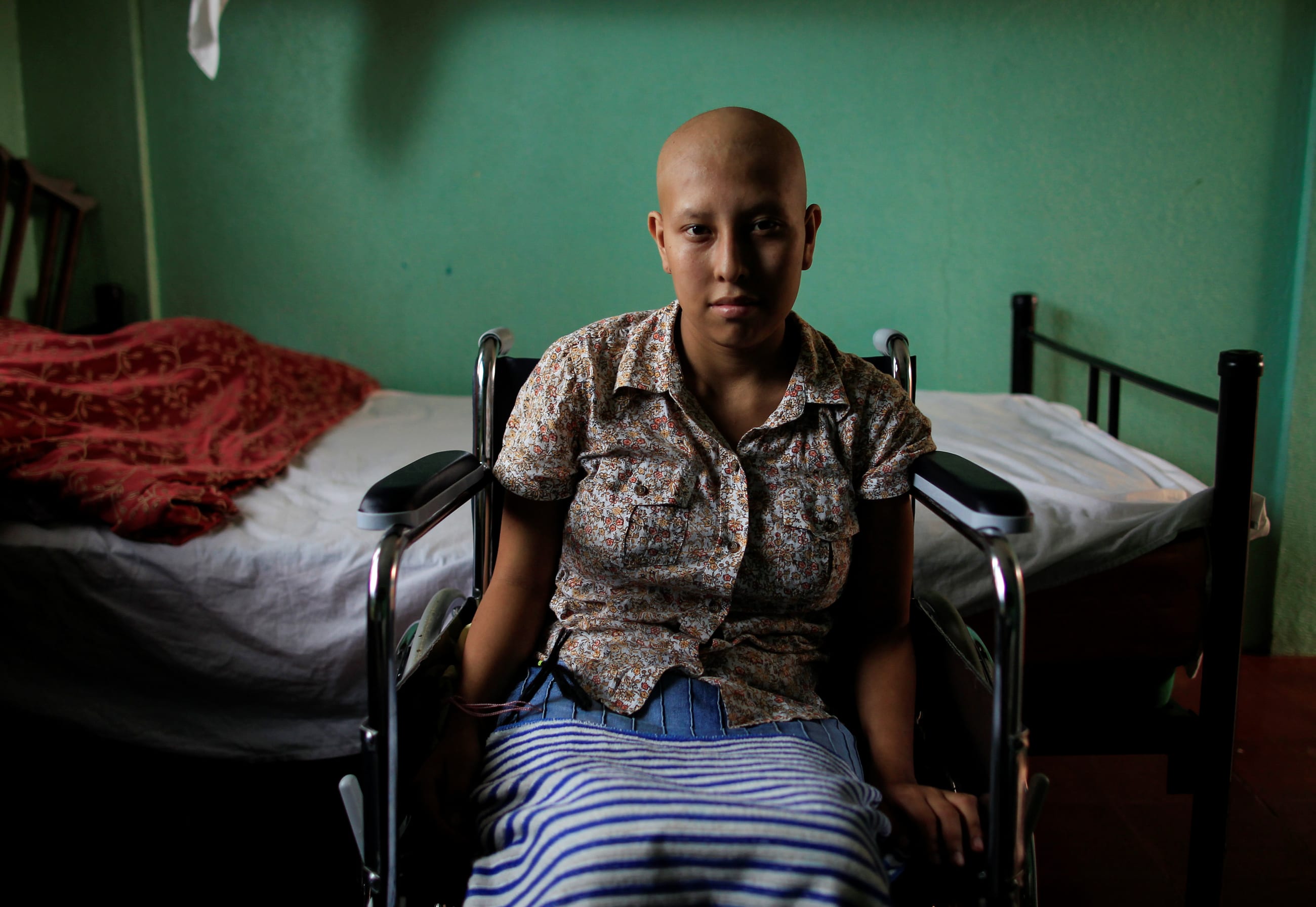 Norma del Carme Blandin, a cancer patient, sits in a wheelchair inside her bedroom, at the Casa-Albergue, in Managua, Nicaragua, on October 20, 2017.