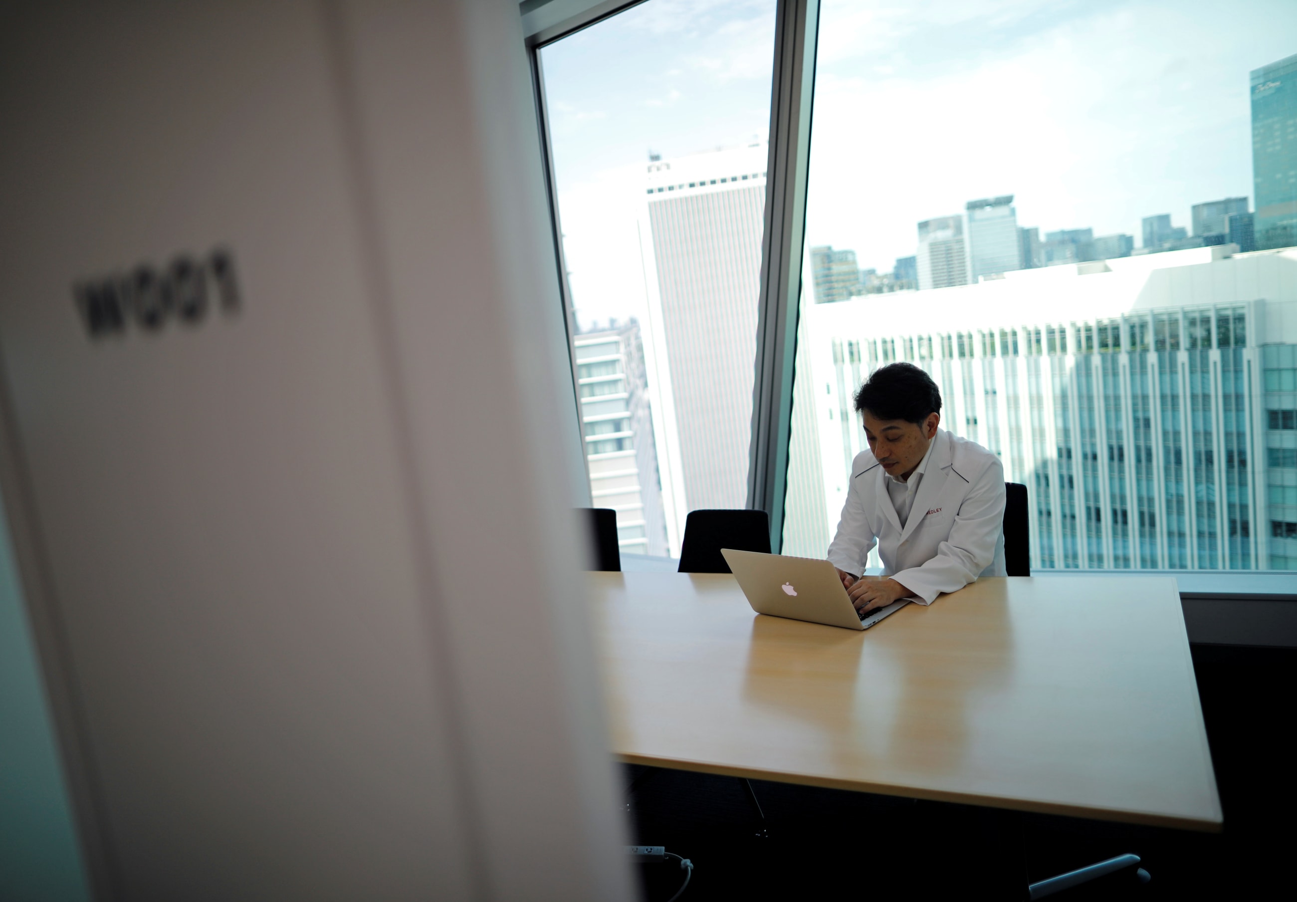 Makoto Kitada, MD, demonstrates a telemedicine application service called 'CLINICS,' in Tokyo, Japan, on July 8, 2020.