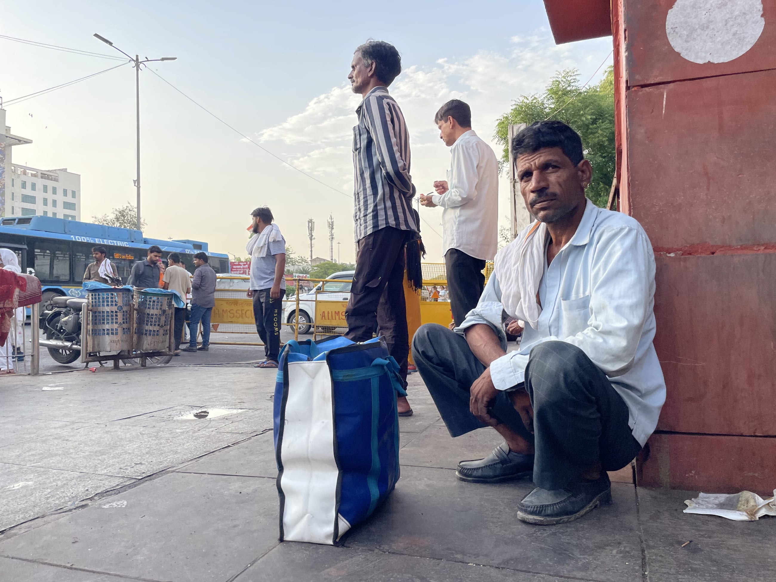 Ramesh Kumar, 45, sits outside a public hospital after another day spent seeking affordable tuberculosis treatment, at Ram Manohar Lohia Hospital, in New Delhi, on November 28, 2025.