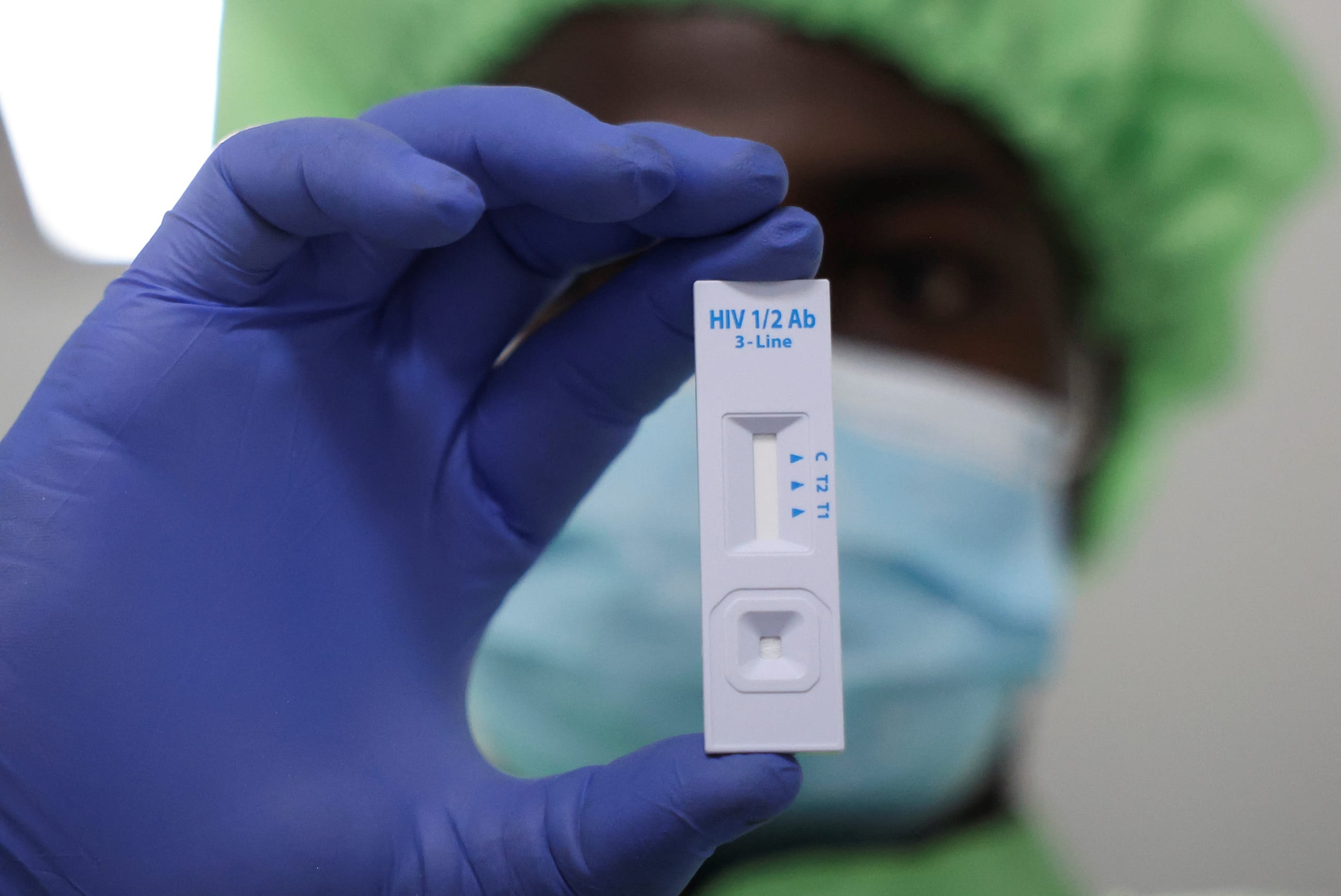 A worker displays a plastic test cassette for HIV 1/2 at Codix Bio production plant where HIV and Malaria test kits are locally produced, as it aims to fill the gap left by U.S. funding cuts to USAID, in Iperu-Remo in Ogun State, Nigeria, on June 18, 2025.