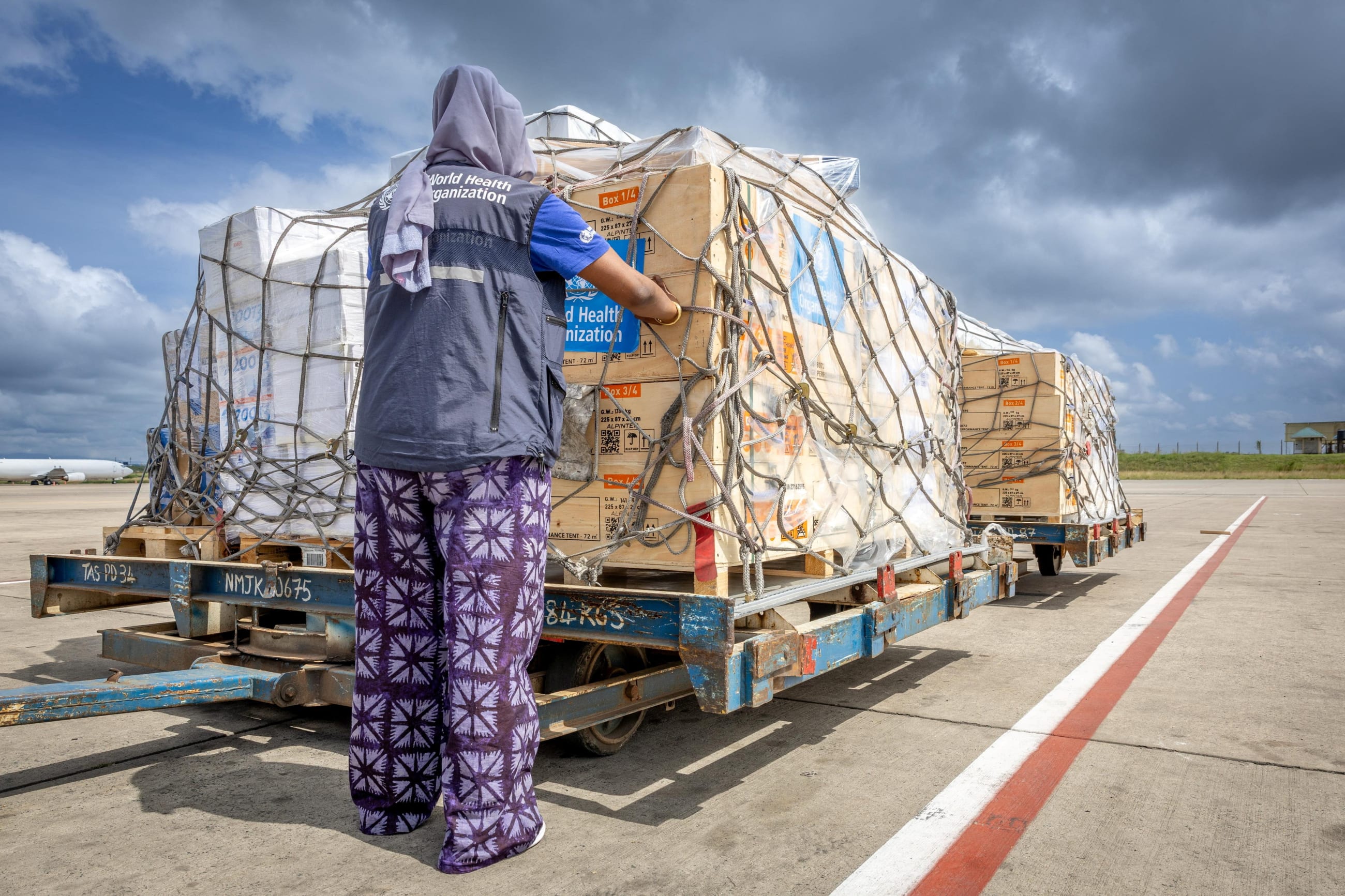 The regional supply chain lead for emergencies at the World Health Organization's Regional Office for Africa pastes stickers on shipment pallets that are being sent in response to the Ebola outbreak in the Democratic Republic of Congo, in Nairobi, Kenya, on May 18, 2026.