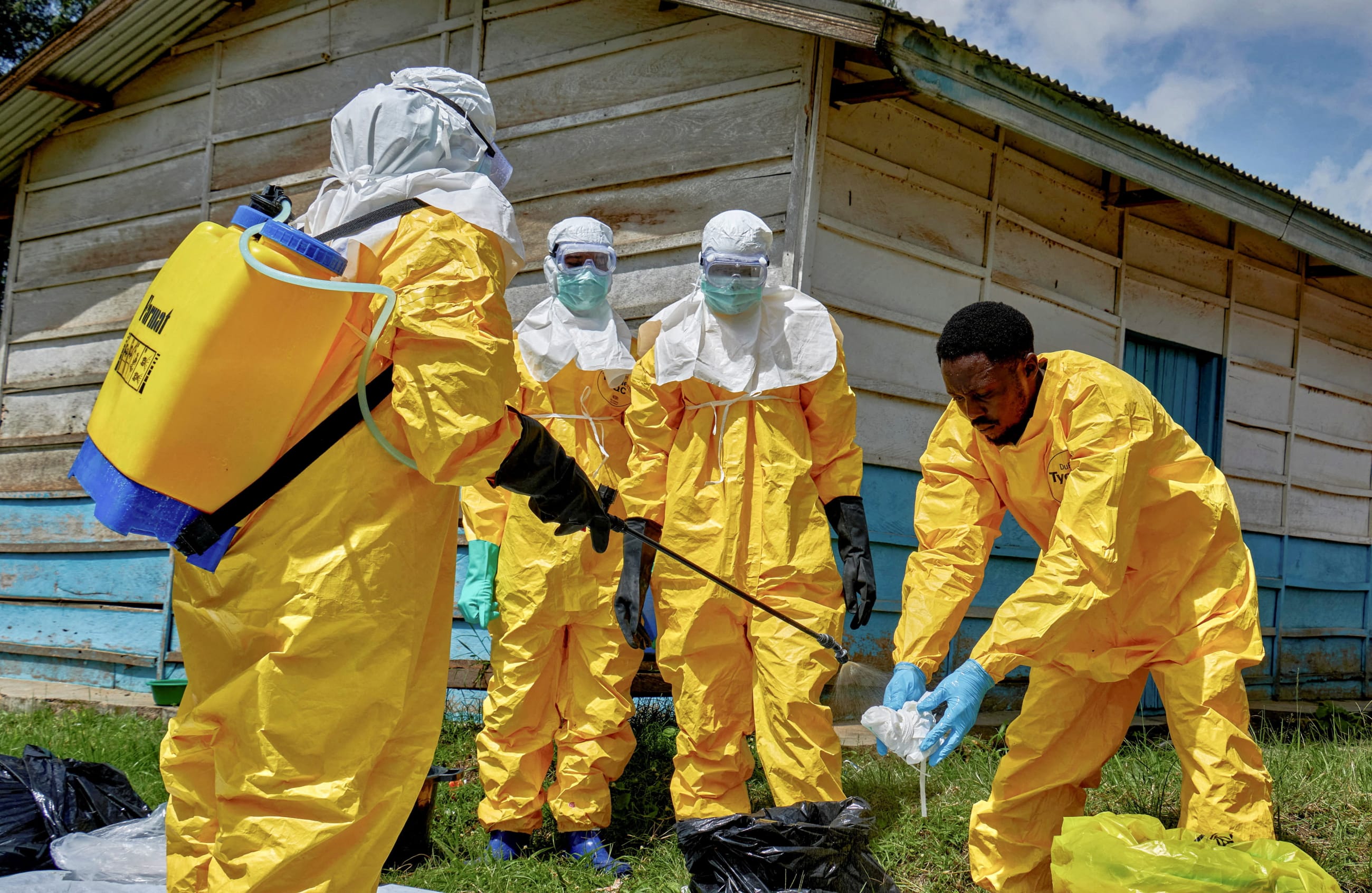 Red Cross workers disinfect after handling the body of a person who died of Ebola, as aid agencies intensify efforts to contain a new Ebola Bundibugyo outbreak, at the Centre Medical Evangelique, in Hoho commune of Bunia, Ituri province, the Democratic Republic of Congo, on May 21, 2026.
