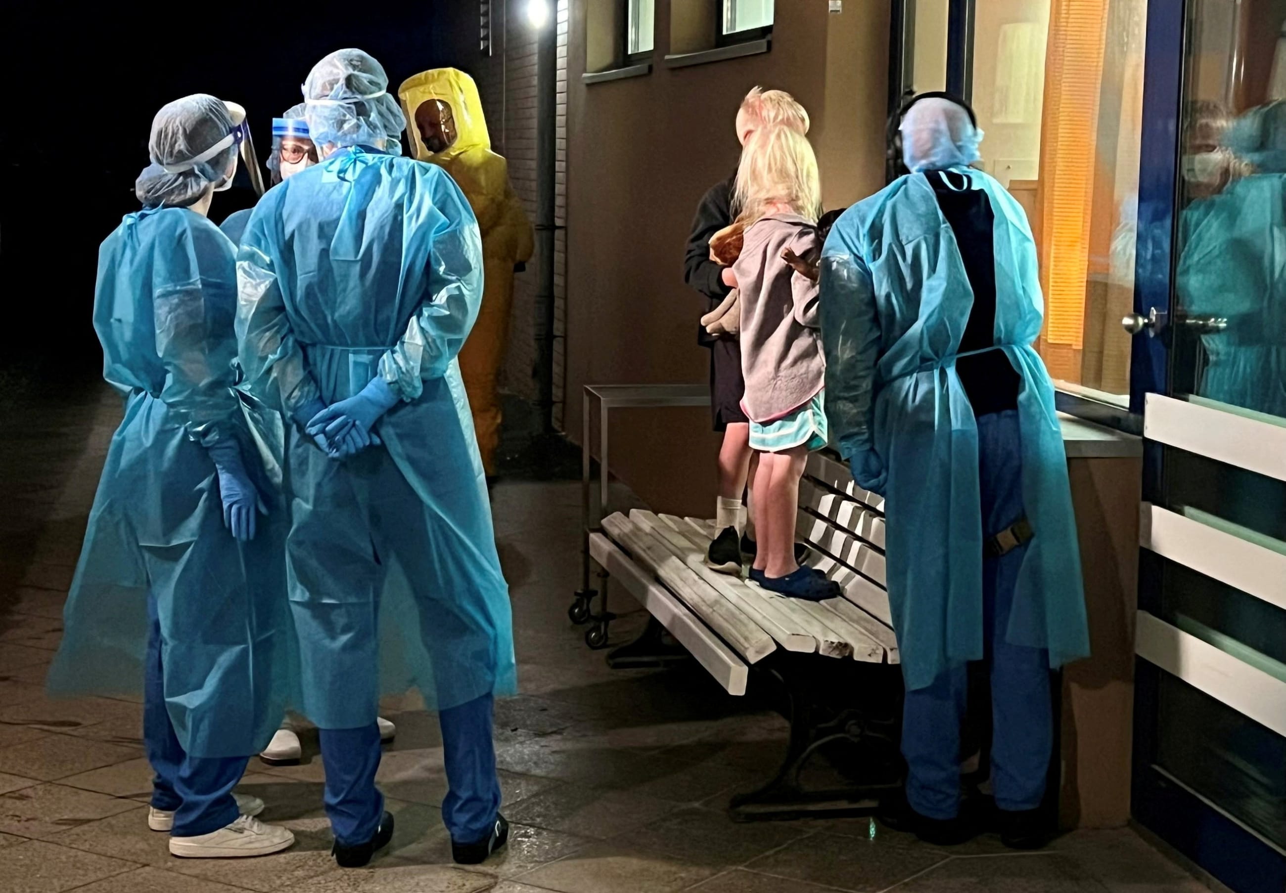 Two children of an American Ebola patient look through a window at their father in the isolation ward, at the Charite hospital in Berlin, Germany, on May 21, 2026.