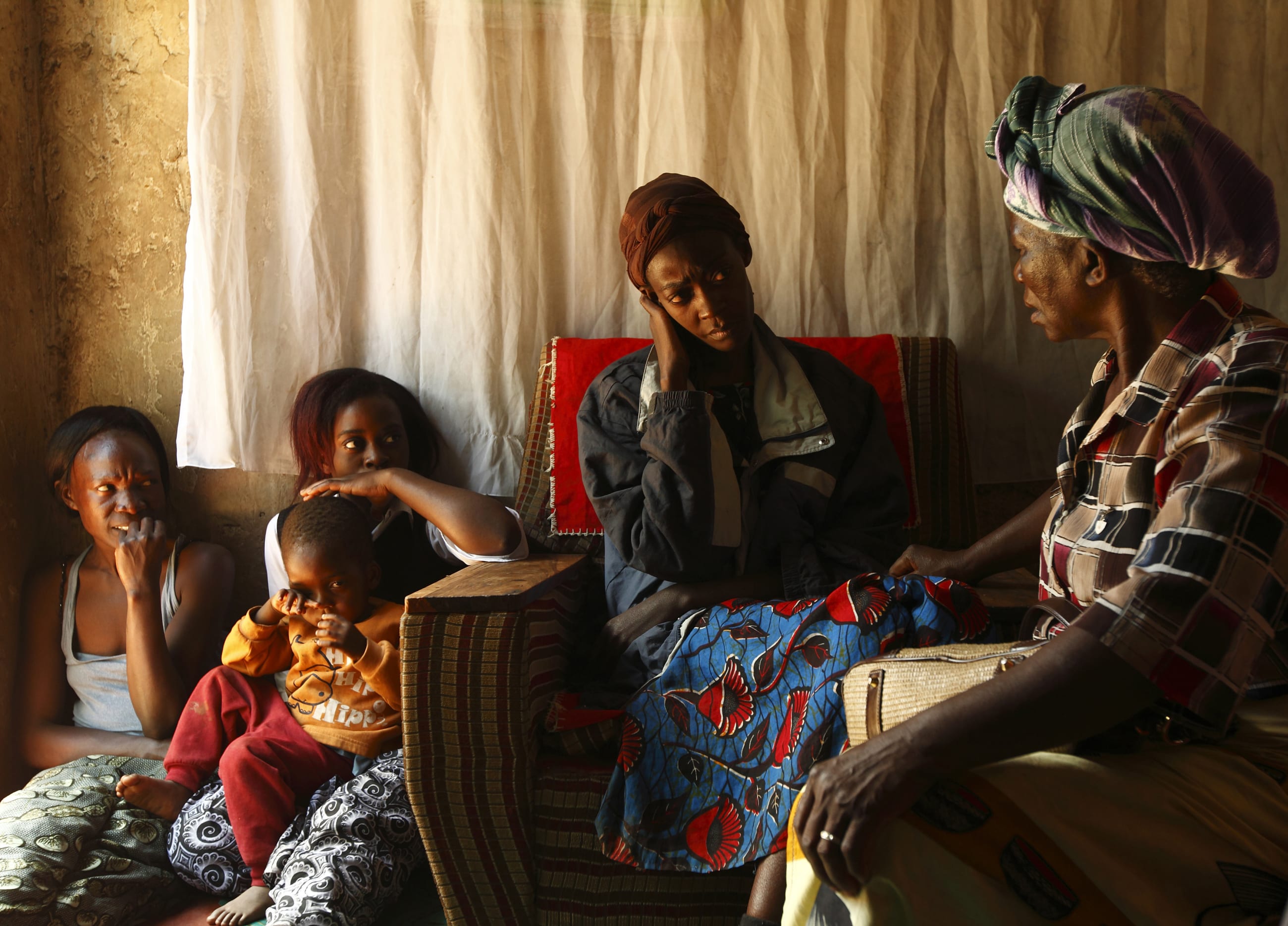 A home-based caregiver visits an HIV/AIDS patient in her home in Matero township, Lusaka, Zambia, on April 17, 2012.