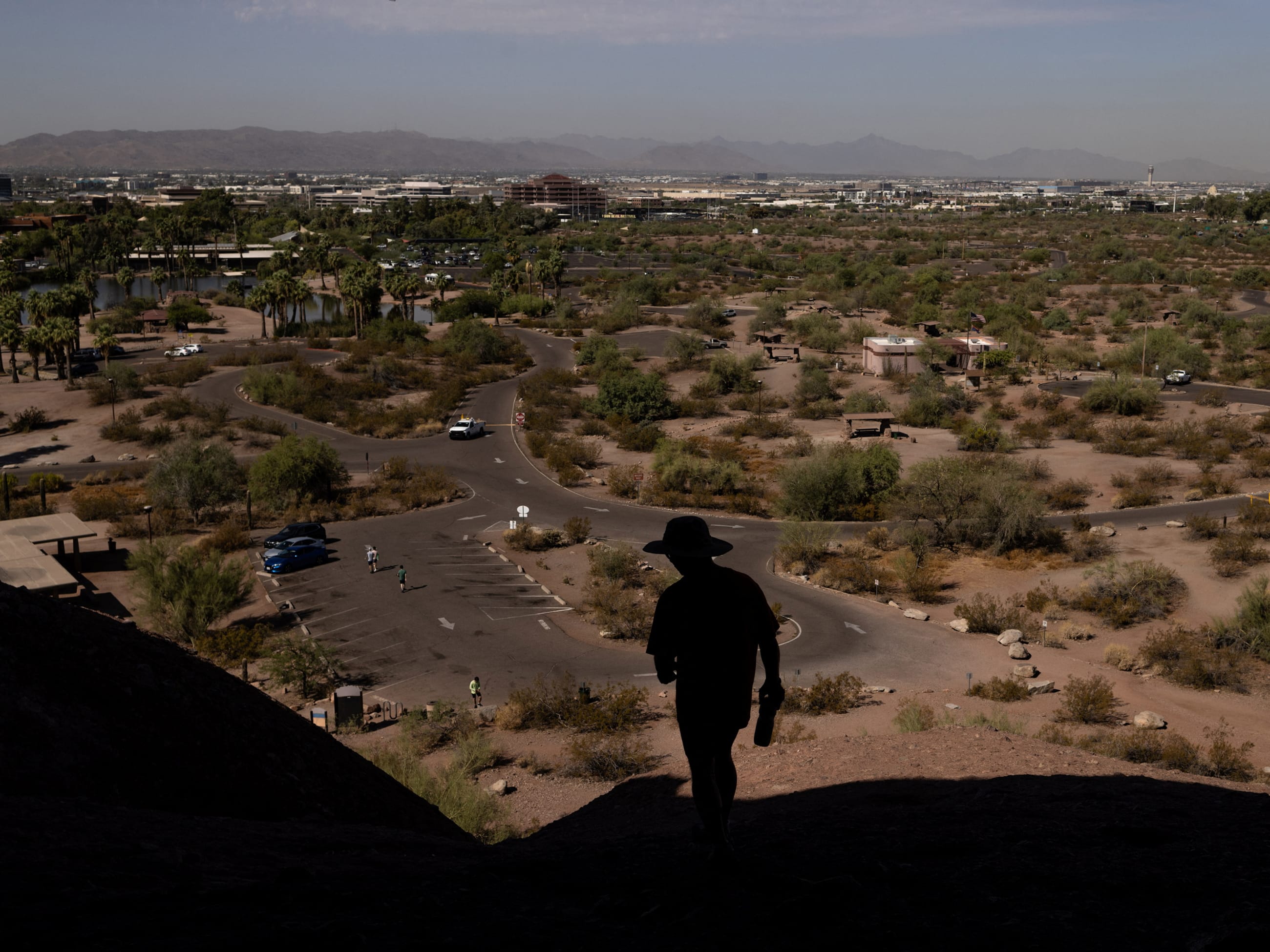 A man walks on a trail during a 27 days long heat wave with temperatures over 110 degrees Fahrenheit (43 degrees Celsius), in Phoenix, Arizona, on July 26, 2023.