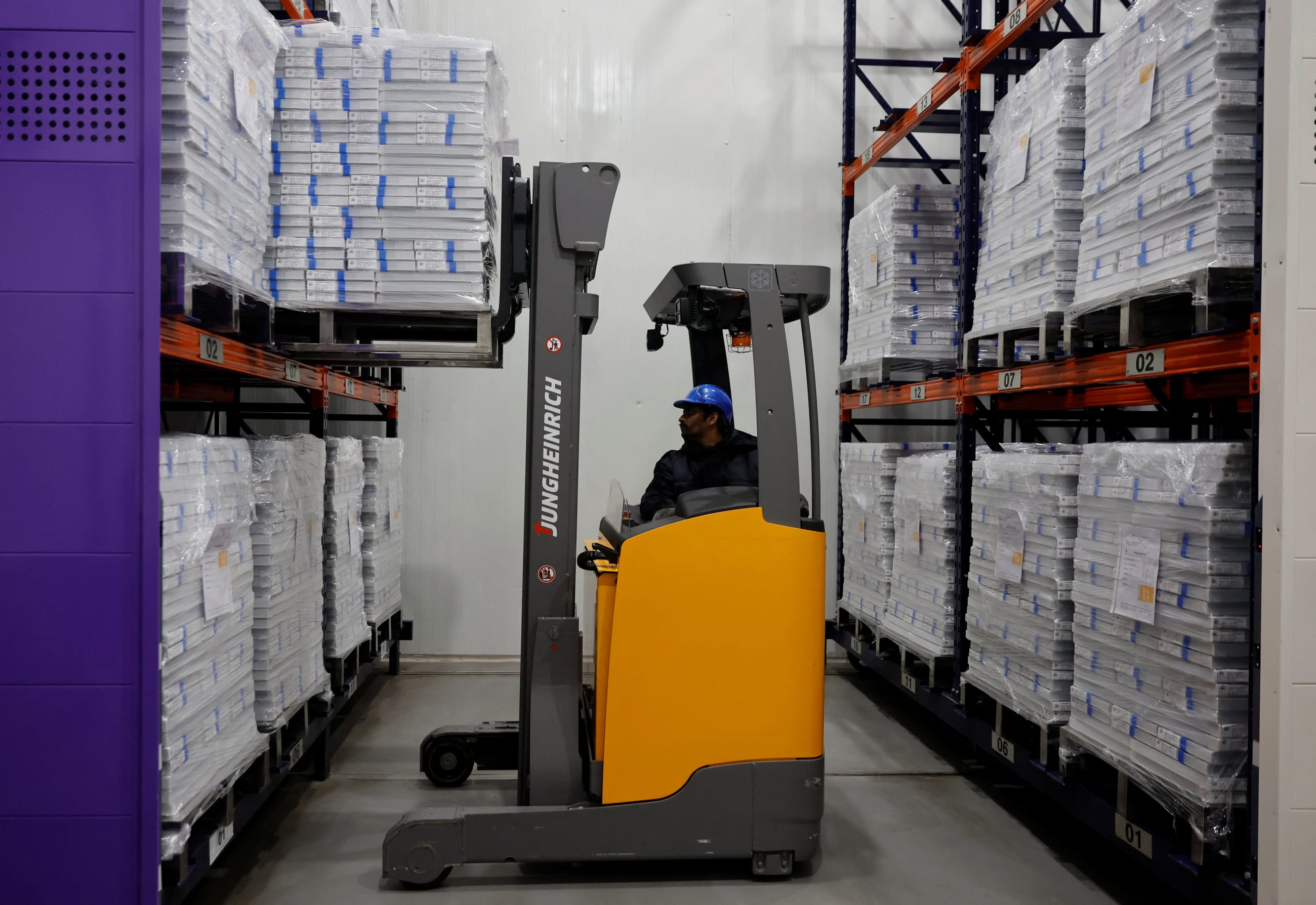A forklift unloads boxes containing vials of the R21 malaria vaccine inside a cold room at the Serum Institute of India, in Pune, India, on February 27, 2024.
