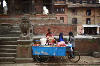 A woman sells beans and snacks at her food stall, in Lalitpur, Nepal, on April 26, 2013.