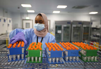 A lab technician works at the Amazon COVID-19 testing lab, in Worsley, Britain, on June 2, 2021.