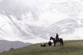 People gather before the Kyrgyz national horse games and festival, near the Tulpar-Kul lake, in the Chon Alai mountain range, in the Osh region of Kyrgyzstan, on July 25, 2015.