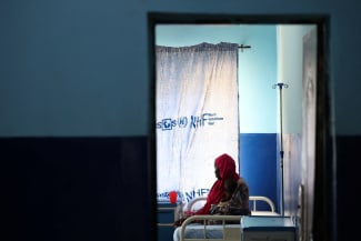 A woman and her child, who is suffering from malnourishment, wait for care at the emergency ward of Dikwa Primary Health Center, where children are stabilized for severe malnutrition, following the withdrawal of USAID support, in Dikwa, Borno State, Nigeria, on August 27, 2025.
