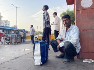 Ramesh Kumar, 45, sits outside a public hospital after another day spent seeking affordable tuberculosis treatment, at Ram Manohar Lohia Hospital, in New Delhi, on November 28, 2025.