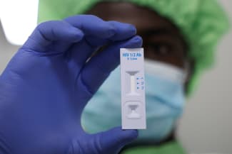 A worker displays a plastic test cassette for HIV 1/2 at Codix Bio production plant where HIV and Malaria test kits are locally produced, as it aims to fill the gap left by U.S. funding cuts to USAID, in Iperu-Remo in Ogun State, Nigeria, on June 18, 2025.