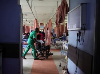 An injured patient is wheeled out of the out-patient ward of the National Orthopaedic Hospital, in Lagos, Nigeria, on July 30, 2025.