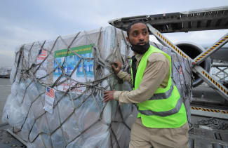 An Ethiopian Cargo terminal worker offloads a shipment of Johnson and Johnson's COVID-19 vaccines that arrived under the COVAX scheme, at the Bole International Airport, in Addis Ababa, Ethiopia, on July 19, 2021.