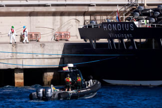 Civil guard members approach the cruise ship MV Hondius, affected by a hantavirus outbreak, on a motorboat, at the port of Granadilla de Abona, Tenerife, Spain, on May 11, 2026.