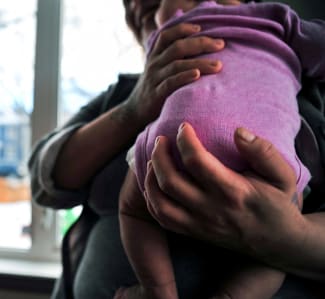 A woman holds her baby at the Sanctum Hospice and Care Home, in Saskatoon, Saskatchewan, Canada, on January 26, 2023.