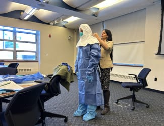 A volunteer is guided through the full donning sequence for special pathogen personal protective equipment during a training seminar led by Syra Madad, chief biopreparedness officer for NYC Health + Hospitals, on February 2, 2026.