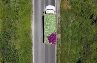 A drone view shows a truck transporting fresh produce after leaving the installations of U.S. supplier Taylor Farms, following the temporary closure announced by Taylor Farms, in Doctor Mora, Guanajuato state, Mexico, on July 24, 2026.