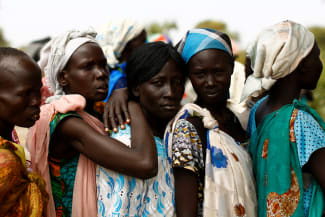 Women wait in line to be seen at a UNICEF supported mobile health clinic, in the village of Rubkuai, Unity State, South Sudan, on February 16, 2017.