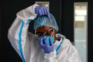 A nurse puts on a protective mask, at Nairobi Hospital, in Nairobi, Kenya, on October 7, 2026.
