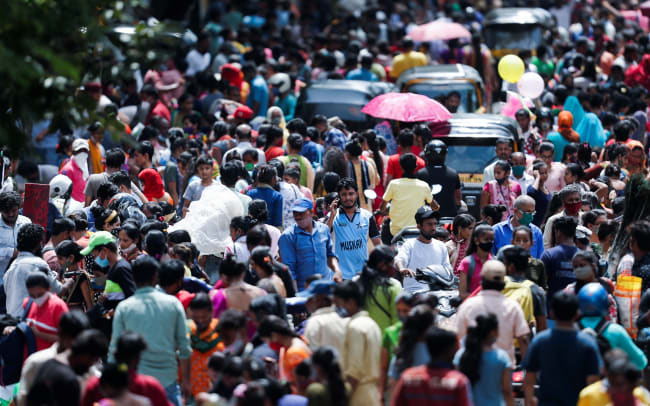 People walk at a crowded market, in Mumbai, India, on August 11, 2021.