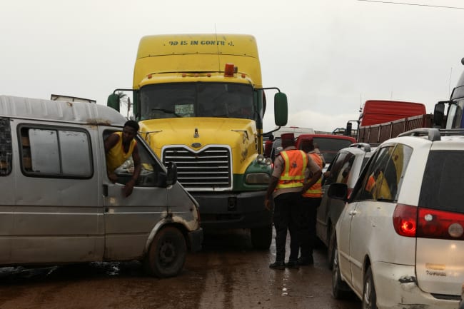 Road safety officers stand, as traffic is blocked up on a road, in Lokoja, Nigeria, on October 13, 2022.