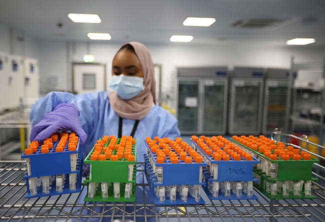 A lab technician works at the Amazon COVID-19 testing lab, in Worsley, Britain, on June 2, 2021.