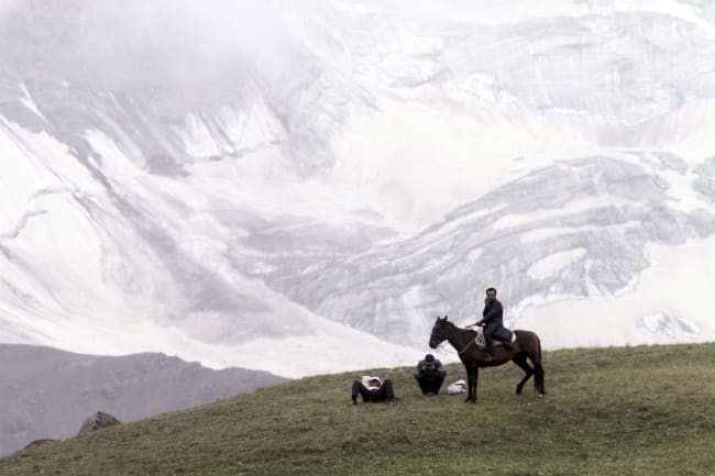 People gather before the Kyrgyz national horse games and festival, near the Tulpar-Kul lake, in the Chon Alai mountain range, in the Osh region of Kyrgyzstan, on July 25, 2015.