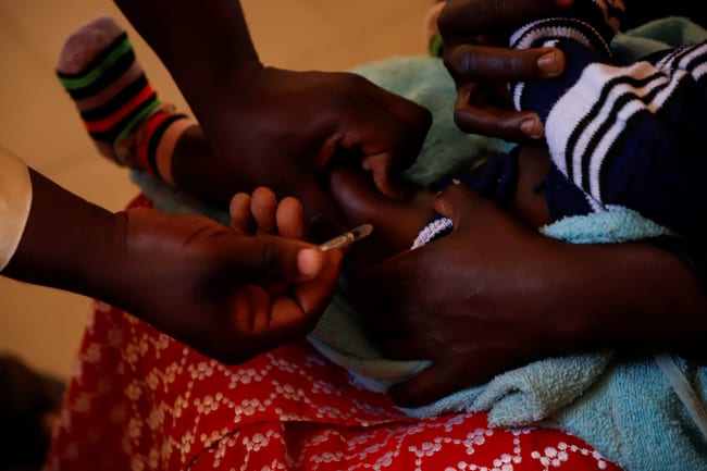 A nurse administers a malaria vaccine to an infant at the health center in Datcheka, Cameroon January 22, 2024. REUTERS/Desire Danga Essigue