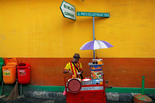 A street vendor prepares drinks for sale at Jatinegara, a traditional market in Jakarta, Indonesia, on May 21, 2020.