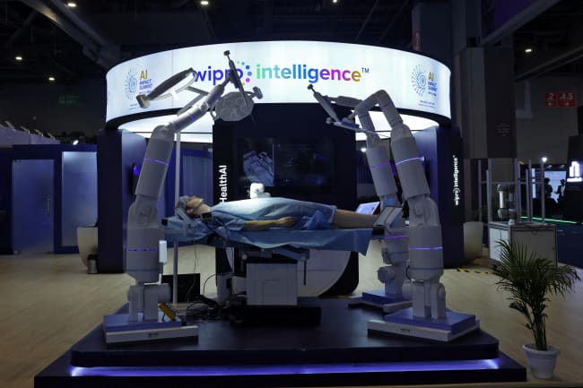 A model of a robotic surgical system by Wipro Intelligence is exhibited at Bharat Mandapam, at the AI Impact Summit, in New Delhi, India, on February 16, 2026.