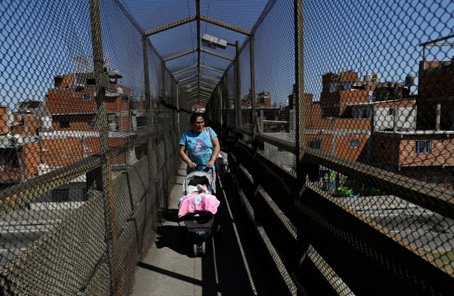 A woman pushes a baby stroller, in Villa Soldati, Argentina, on September 16, 2024.