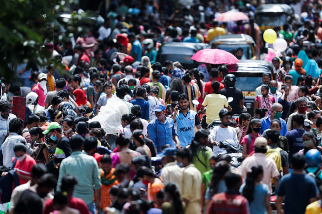 People walk at a crowded market, in Mumbai, India, on August 11, 2021.