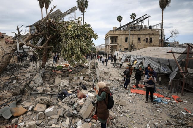 Palestinians inspect the damage after two Israeli missiles hit a building inside the Al-Ahli Arab Baptist Hospital, in the Gaza Strip, on April 13, 2025.t the liquid oxygen storage tank installed at Bir Hospital by the United States Agency for International Development, in Kathmandu, Nepal, on February 9, 2025.