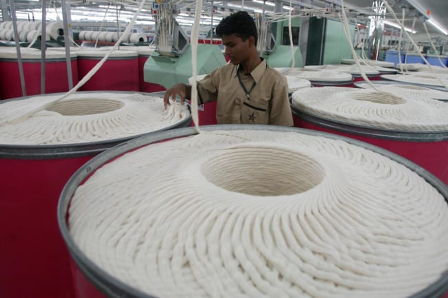 An employee works inside the Century Textiles and Industries Ltd. textile mill, in Gujarat, India, on October 22, 2009.