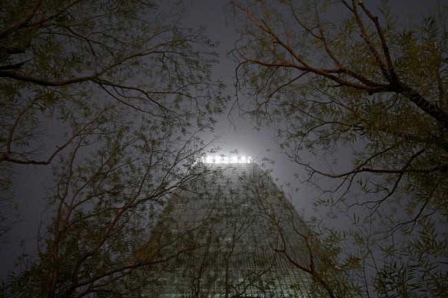 A building is pictured through trees amid heave smog on a polluted day, in Beijing, China, on December 2, 2018.