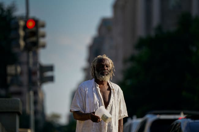 Nathaniel, who is homeless, panhandles near the National Mall after U.S. President Donald Trump federalized the Metropolitan Police Department and deployed National Guard to assist in crime prevention, in Washington, DC, on August 15, 2025.