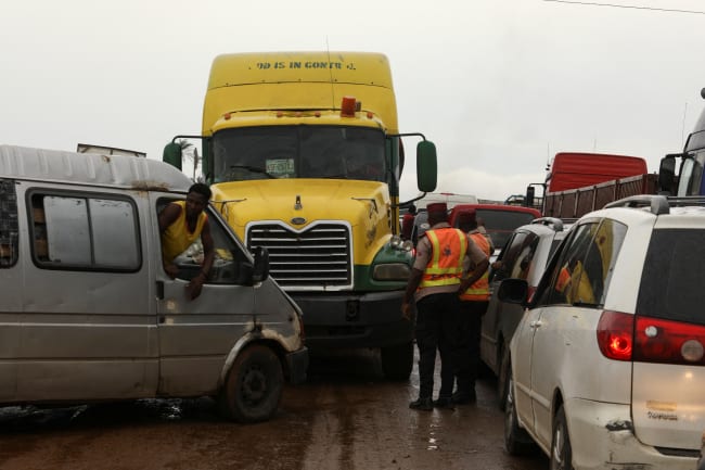 Road safety officers stand, as traffic is blocked up on a road, in Lokoja, Nigeria, on October 13, 2022.