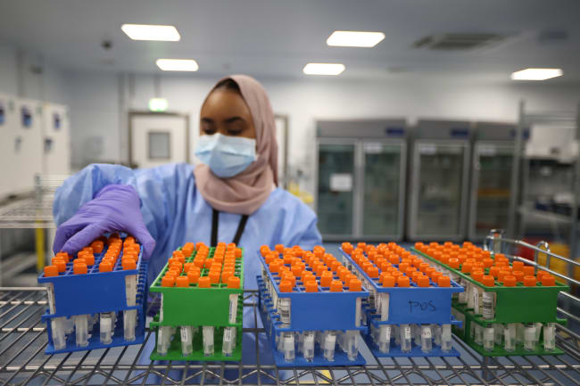 A lab technician works at the Amazon COVID-19 testing lab, in Worsley, Britain, on June 2, 2021.
