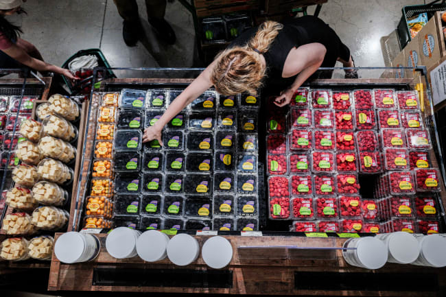 People shop for groceries at a store in New York City, New York, on July 15, 2025.