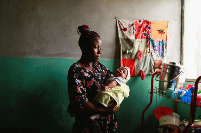 Jocelyne Mitoba, who was detained for eight days with her baby for lack of money at Bethesda Medical Center, holds her newborn at her home, in Ngaba, a neighborhood of Kinshasa, Democratic Republic of Congo, on February 18, 2023.