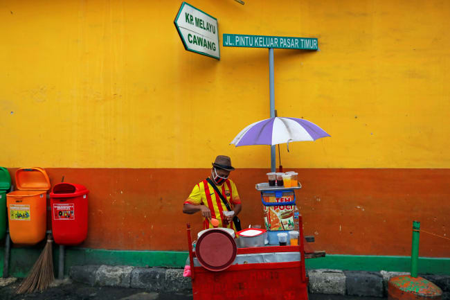 A street vendor prepares drinks for sale at Jatinegara, a traditional market in Jakarta, Indonesia, on May 21, 2020.
