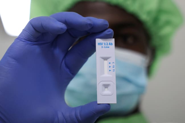 A worker displays a plastic test cassette for HIV 1/2 at Codix Bio production plant where HIV and Malaria test kits are locally produced, as it aims to fill the gap left by U.S. funding cuts to USAID, in Iperu-Remo in Ogun State, Nigeria, on June 18, 2025.