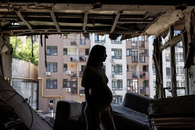 Bohdana Zhupanyna, a 30-year-old mother-to-be, stands inside her apartment that was damaged by a Russian drone strike, in Kyiv, Ukraine, on July 23, 2025.